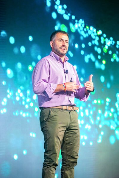 Field engineer presenting on stage at GE Verona Conference in Arizona