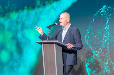 Presenter speaking on stage at GE Verona corporate event in Scottsdale