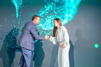 Speaker shaking hands on stage during GE Verona Conference in Scottsdale and Phoenix